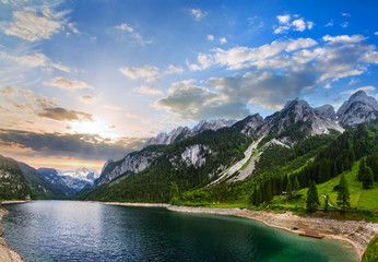 Naklejka na ściany i meble Alpine summer lake sunset panorama.