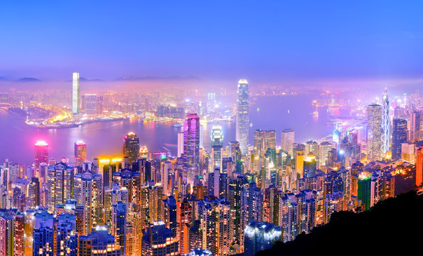 Victoria Harbor and Hong Kong skyline at dusk.