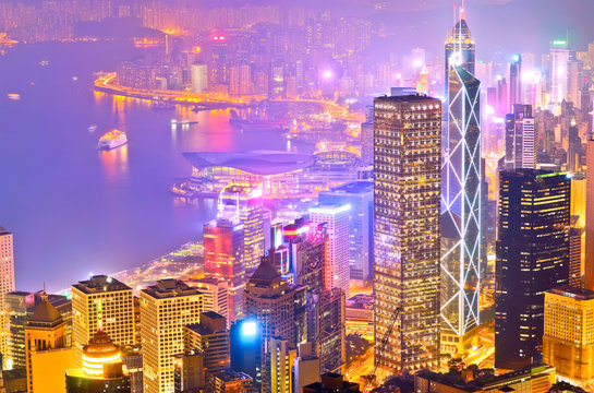 Victoria Harbor and Hong Kong skyline at night.