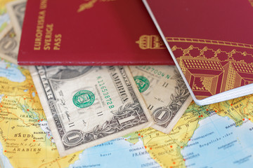 Passport and US dollar bill on a map of Asia