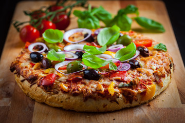 Traditional homemade pizza with tomatoes and olives