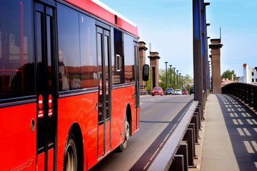 City cars on bridge. Street traffic with red bus. Public transport.