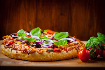 Traditional homemade pizza with tomatoes and olives