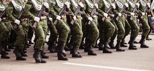 Soldiers in green dress uniform marching on the spot