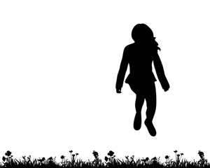 isolated, silhouette of a teenager jumping on the grass