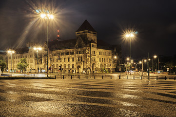 Paved square and street crossing at night in Poznan.