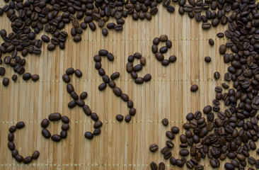 coffee beans on wooden background with the words "coffee"
