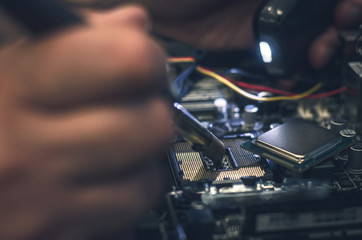 Computer processor. Technician removes CPU from the motherboard.
