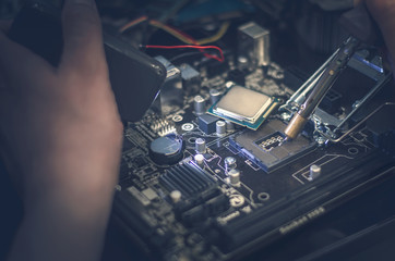 CPU (computer processor). Technician works with motherboard.