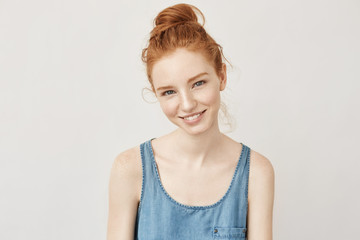 Portrait of appy beautiful redhead girl with freckles smiling sincerely looking at camera not...