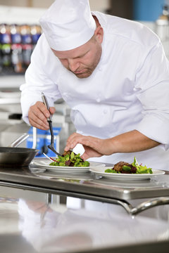 Professional chef prepare steak dish at restaurant