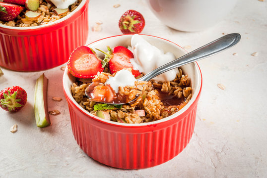 Healthy Breakfast. Oatmeal Granola Crumble With Rhubarb, Fresh Strawberries And Blackberries, Seeds And Ice Cream In Baked Bowls, Decorated With Mint, On White Stone Concrete Table, Copy Space