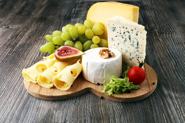 Cheese platter with different cheese and grapes