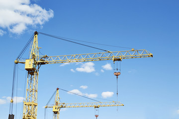 tower cranes on a blue sky background