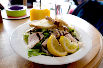 Caesar salad with roasted chicken breast, toasted bread, lettuce, cherry tomatoes and soy sauce served at the restaurant in Novi Sad, Serbia