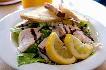 Caesar salad with roasted chicken breast, toasted bread, lettuce, cherry tomatoes and soy sauce served at the restaurant in Novi Sad, Serbia