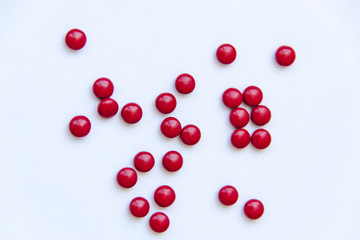 Red pills on white background