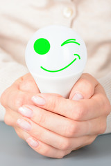 Female hands holding a led light bulb