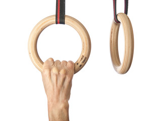 Male hand with gymnastic rings on isolated background