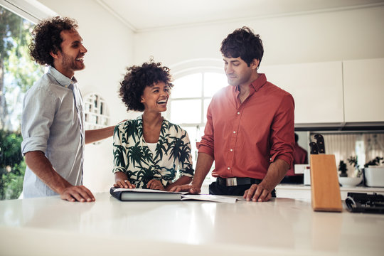 Real estate broker with happy customers in new house