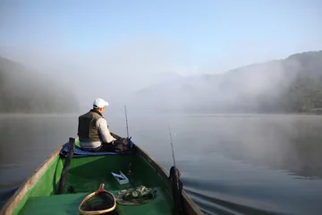 Fotobehang Fisherman in boat / Spin fishing in Solina Lake. © Tramper2
