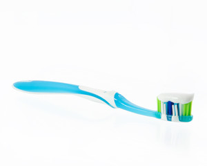toothpaste at a toothbrush at white background