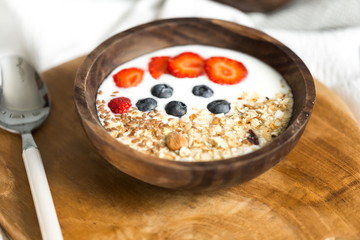 Oatmeal with strawberries and blueberries on a white sheet