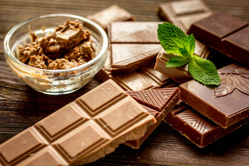 chocolate pieces with mint on wooden table background