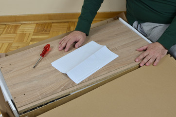 Man preparing to assemble a new piece of furniture
