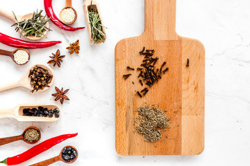 Dry colorful spices, chili pepper on kitchen stone table background top view