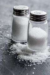 salt in bottle for spices set dark background closeup