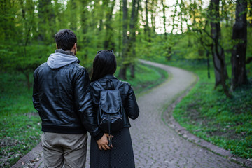 man tocuhs womans ass while walking in park