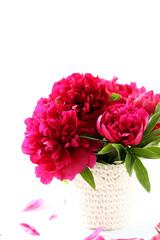 Bouquet of red peony flowers on a white wooden table