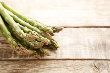 Bunch of green asparagus on grey wooden table