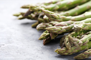 Green asparagus on grey wooden table