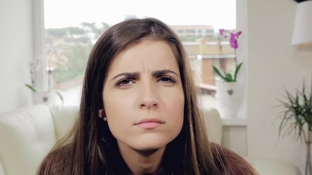 Woman suspicious looking camera closeup slow motion
