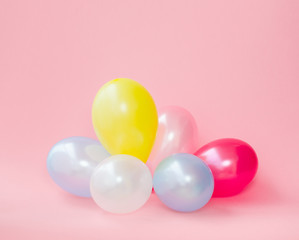 celebration balloons on pink background