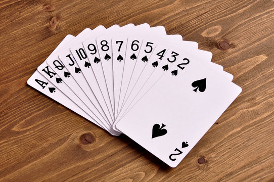 Set of play cards poker casino on  a wooden background