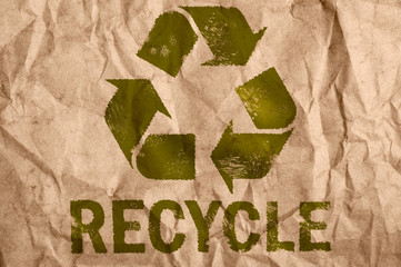rough paper with recycle symbol.