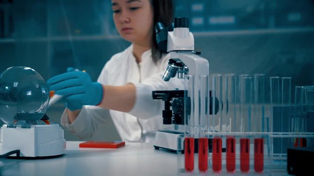 Young woman in microbiological lab