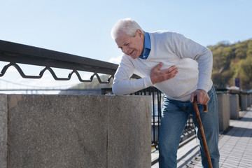 Middle aged man suffering from pain in the street