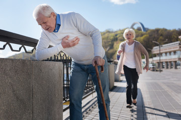 Aged pensioner having pain in his chest on the promenade
