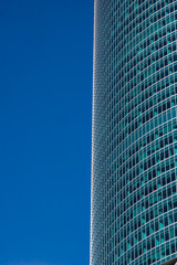 glass reflective office buildings against blue sky