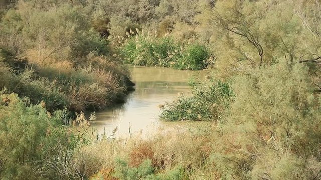 Jordan River in Al-Maghtas - historical place of baptism of Jesus Christ in Jordan, is world heritage site on east bank of Jordan river, officially known as Baptism Site Bethany Beyond the Jordan