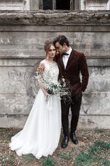 Bride and groom near ancient building