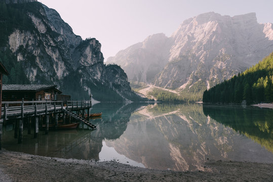 Boathouse in river against mountains