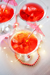 Raspberry cocktail with ice and paper umbrellas