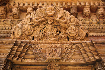 Hindu Temple wooden carved decor of an ancient building of 18 century on Durbar square, Kathmandu, Nepal, Asia. Architectural detail. Gods in Hinduism.