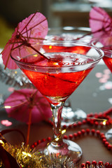 Raspberry cocktail with ice and paper umbrellas