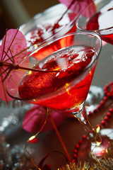 Raspberry cocktail with ice and paper umbrellas